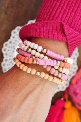 Pink stack of 5 clay and wood beads bracelets in pinks, white and peach